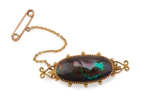 An antique Australian 15ct gold brooch, set with a stunning solid Queensland boulder opal, housed in original retailer's box branded "LYALL'S LTD. JEWELLERS....CHARTERS TOWERS", 19th century, ​​​​​​​4.5cm wide, 8.1 grams
