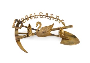 An antique Australian 15ct gold "COOLGARDIE" brooch, with cross pick, shovel and swan adornment, early 20th century, stamped "15ct", 5.5cm wide, 6 grams