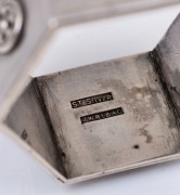 An exceptional antique Australian silver napkin ring of hexagonal Gothic form adorned with floral rosettes and "H" ownership monogram studded with five cabochon rubies, 19th/20th century, stamped "ST. SILVER, J.W.R.L. & A.G.", ​​​​​​​4.5cm wide, 36 grams. - 2