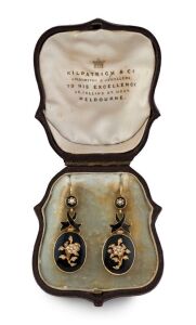 A stunning pair of Australian Colonial antique gold and black enamel earrings adorned with seed pearls in floral motif, housed in a plush fitted leather box with retailer's branding "KILPATRICK & CO. GOLDSMITHS & JEWELLERS TO HIS EXCELLENCY. 39 Collins Street West. MELBOURNE", 19th century, 4.5cm high, 9.9 grams total.