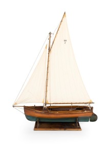 A scratch built model couta boat, on timber stand, 135cm high overall, 101cm long