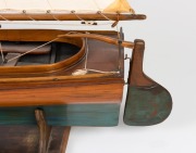 A scratch built model couta boat, on timber stand, 135cm high overall, 101cm long - 2