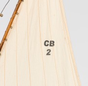 A scratch built model couta boat, on timber stand, 135cm high overall, 101cm long - 3