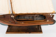 A scratch built model couta boat, on timber stand, 135cm high overall, 101cm long - 4