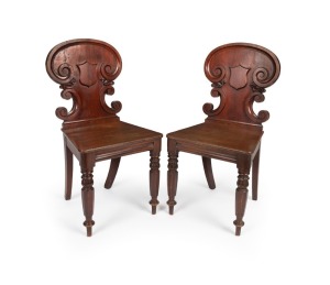 A fine pair of antique Australian cedar hall chairs with shield backs, hexagonal form legs with tulip carved capitals, New South Wales origin, circa 1840s