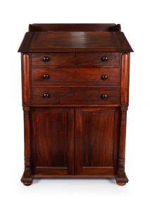A Colonial Australian cedar clerk's cabinet with slope top, dummy drawers, turned columns and interior fitted with drawers and compartments, Tasmanian origin, circa 1845, 158cm high, 100cm wide, 69cm deep