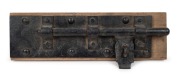 Gaol door antique iron lock, mounted on timber, 19th century, ​​​​​​​55cm wide