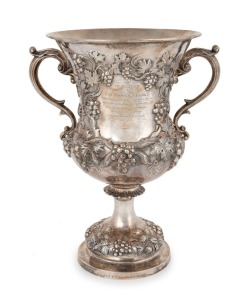 KILPATRICK & Co. MELBOURNE. An antique sterling silver two handled cup with repousee grape decoration engraved "Presented To CAP.tn. EDWARD A. REYNELL, By The Passengers Of The Ship TRUE BRITTON, As A Slight Mark Of Their High Appreciation Of His Constant Kindness And Attention Throughout A Voyage From London To Melbourne, 26th May, 1857", made by George Angell of London, circa 1856, engraved to the foot rim "KILPATRICK & Co. LONDON & MELBOURNE",