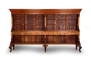 BRADLEY, NEWTON & LAMB of&nbsp;Sydney. An impressive Antique Australian open library bookcase. The upper section with fixed shelves supported by turned columns&nbsp;and flanked by carved acanthus corbels and ogee moulded cornice with solid top. The lower section fi
