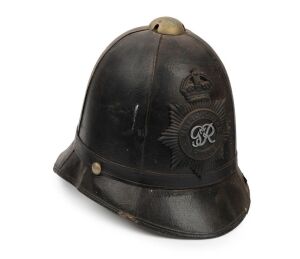 An Australian police "Bobby" helmet with George V hat plate, bearing original paper label "A.W. SUDWEEKS MANUFACTURER, BALLARAT", circa 1910.