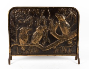 A vintage pressed brass firescreen with kookaburra decoration, circa 1930s, 58cm high, 71cm wide, 13cm deep