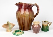 REMUED&nbsp;large pink and brown pottery jug with branch handle (A/F), together with a REMUED ashtray, vase, jug and basket vase, (5 items), the largest 25cm high