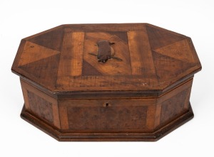 An unusual Australian folk art octagonal sewing box with applied kookaburra decoration, attractively crafted in fine cuts of blackwood, totara and maple, interior fitted with salmon pink silk, early 20th century, ​​​​​​​14cm high, 38cm wide, 26cm deep.