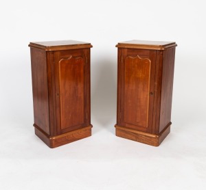A pair of antique stained kauri pine bedside cabinets with shield doors, 19th century, 77cm high, 39cm wide, 32cm deep