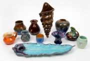 BENNETT POTTERY wall pocket, HAGUE blue and purple glazed leaf tray, orange glazed cream jug, brown and green glazed cream jug, blue glazed basket vase and six assorted pottery vases, (11 items), the largest 34cm wide