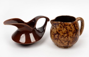 Two Australian pottery water jugs, one by Fowler Ware Australia in dark brown glaze, the other with brown mottled glaze. 20th century, the Fowler 14cm high.