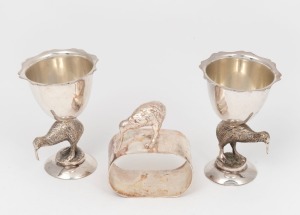 65 · A pair of antique silver plated New Zealand kiwi bird eggcups, together with a silver plated kiwi bird napkin ring, 19th/20th century, (3 items) the eggcups 7.5cm high.