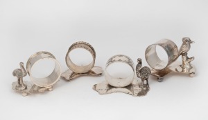 91 · Four assorted antique silver plated napkin rings with Australian map bases and animal decoration, 19th/20th century, ​​​​​​​the largest 6cm high.