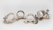Four assorted antique silver plated napkin rings with Australian map bases and animal decoration, 19th/20th century, ​​​​​​​the largest 6cm high.