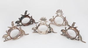 Five assorted antique silver plated napkin rings with Australian maps, kookaburras, emus, boomerangs and kangaroos, by STOKES & SONS of Melbourne, 19th/20th century, the largest 8cm high, 11cm wide.