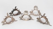 Five assorted antique silver plated napkin rings with Australian maps, kookaburras, emus, boomerangs and kangaroos, by STOKES & SONS of Melbourne, 19th/20th century, the largest 8cm high, 11cm wide.