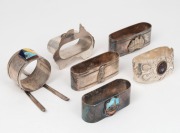 Six assorted antique and vintage silver plated napkin rings with Australian themes, four with enamel decoration. Makers include STOKES & SONS, RITCHER,&nbsp;and ANGUS & COOTE, 20th century, the largest 5cm high.