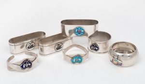 Seven assorted sterling silver Australian themed napkin rings all with enamel decoration, 20th century, the largest 7cm wide, 182 grams total.