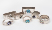 Seven assorted sterling silver Australian themed napkin rings all with enamel decoration, 20th century, ​​​​​​​the largest 7cm wide, 182 grams total.