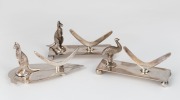 Three antique silver plated knife rests with boomerangs, kangaroos and emu, early 20th century, 5cm high, 10cm wide.