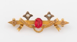ARONSON & Co. of Melbourne, antique 9ct gold "GOOD LUCK" bar brooch, set with red stone and seed pearls, and housed in a period box, 19th century, stamped "9ct" with pictorial marks, 4.6cm wide, 2.7 grams