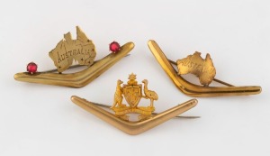 Three antique Australian 9ct gold boomerang brooches, two with maps of Australia, the other with Australian coat of arms, 19th/20th century, the largest 5.2cm wide, 7.9 grams including stones.