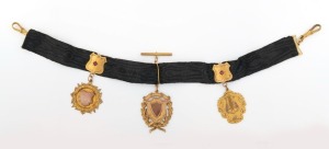 WILLIS & SONS of Melbourne antique 9ct gold and woven black silk watch chain with three fob medallions, one engraved "EAGLEHAWK MUSICAL COMPETITION,1915, First Core Solo, Gift of A.P. SYKES", early 20th century, (note: gold plated bulldog clasps), 35cm lo