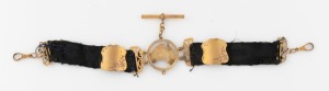 An antique 9ct gold and woven black silk&nbsp; watch chain with Australian map and engraved shields, early 20th century, (note: silk in poor condition), ​​​​​​​21cm long, 9.7 grams total weight including silk.