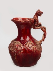 MABEL GIBSON rare pottery jug with sgraffito, applied tree decoration and faun handle, glazed in burgundy, incised "Mabel B. Gibson, 1936", 21cm high