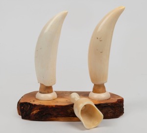 217 · A vintage whale's tooth desk ornament mounted on huon pine base; together with a whale's tooth sugar scuttle scoop, 20th century, (2 items), the ornament 19cm high overall