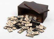 Antique whalebone and ebony dominoes, housed in a later dark stained timber box, 19th century, the tiles 4.5cm long