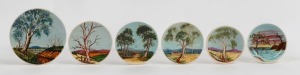 331 · GUY BOYD group of six pottery dishes and plaques with hand-painted Australian landscapes on blue ground, all incised "Guy Boyd", the largest 15.5cm diameter.