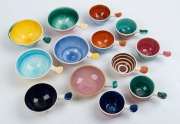ARTHUR MERRIC BOYD group of 15 assorted ramekins with hand-painted coloured decoration, all incised with potter's marks, the largest 17cm wide.