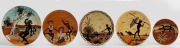 GUY BOYD & MARTIN BOYD group of five pottery plaques with sgraffito and hand-painted Aboriginal scene decoration, the largest 26.5cm diameter.