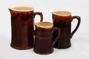 248 · BENDIGO pottery graduated set of three brown glazed jugs, the largest 20cm high