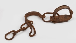 140 · Convict leg irons, 19th century, 56cm wide.