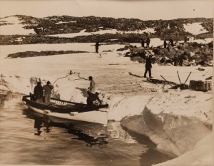 THE B.A.N.Z. ANTARCTIC EXPEDITION: Official original photograph by Captain Frank Hurley: Image B32 - Title: Mawson Revisits Former Winter Quarters, with official "MAWSON ANTARCTIC EXPEDITION" handstamp&nbsp;and release date "TUESDAY MAY 19, 1931" verso, togeth
