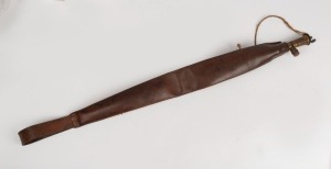 An antique leather shot flask of elongated form with should strap, 19th century, ​​​​​​​67cm long.