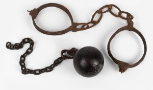 157 · Convict leg irons in relic condition, together with a convict ball with later chain, 19th century, (2 items), ​​​​​​​the irons 50cm wide.