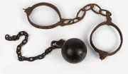 Convict leg irons in relic condition, together with a convict ball with later chain, 19th century, (2 items), ​​​​​​​the irons 50cm wide.