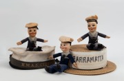 Three sailor souvenir dolls, together with a straw boater with PARRAMATTA&nbsp;hatband and a sailor's hat with "H.M.A.S. CERBERUS" hatband, (5 items).
