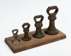 BELL WEIGHTS four graduated examples in timber mount, 19th century, ​​​​​​​the largest 7lb