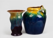 REMUED&nbsp;pottery vase with applied branch handle glazed in blue, yellow and green; together with an unusual REMUED pottery vase with flared rim, glazed in rare purple, green and yellow with brown interior, (2 items), 23.5cm and 19cm high