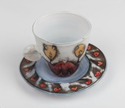 MICHAEL AQUINO hand-painted Australian art glass cup and saucer, the saucer 15.5cm wide