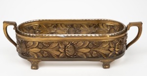 An antique German brass centrepiece with waratah decoration and original glass liner, by Wilhelm Wolff, Pforzheim, circa 1920, 12cm high, 41cm wide.